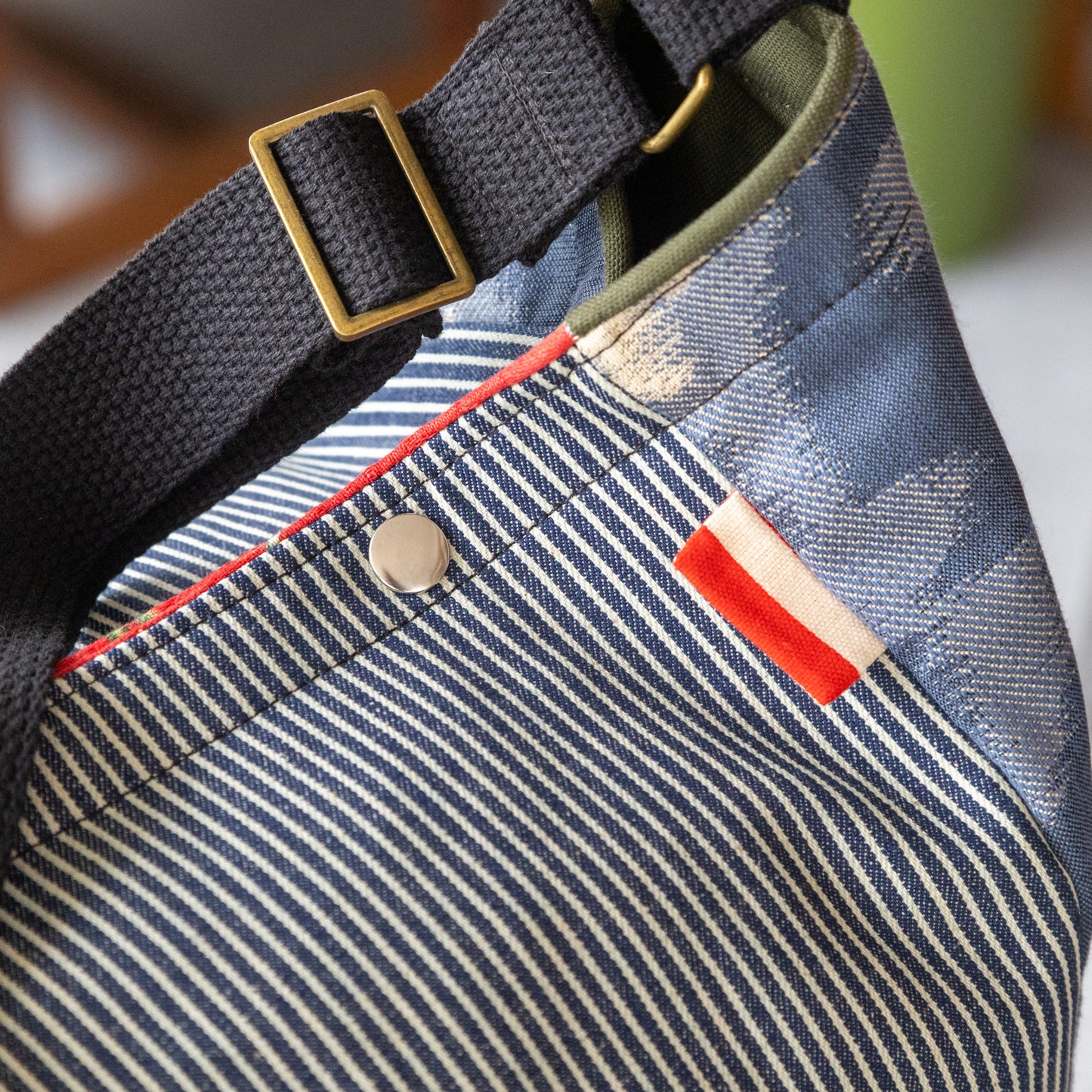 Shoulder bag in hickory stripe, ikat panels, and lush red interior