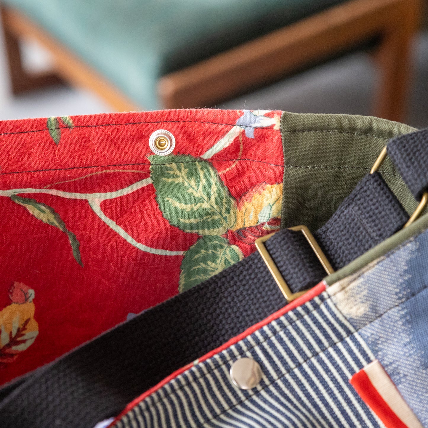 Shoulder bag in hickory stripe, ikat panels, and lush red interior