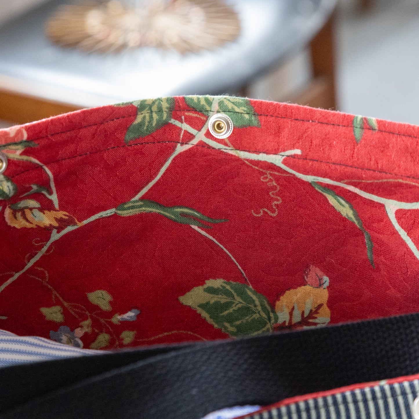 Shoulder bag in hickory stripe, ikat panels, and lush red interior